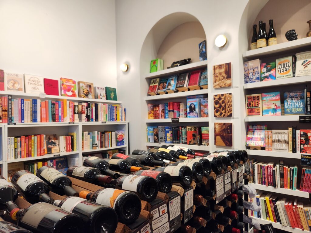 Inside Book + Bottle: shelves of books and wine