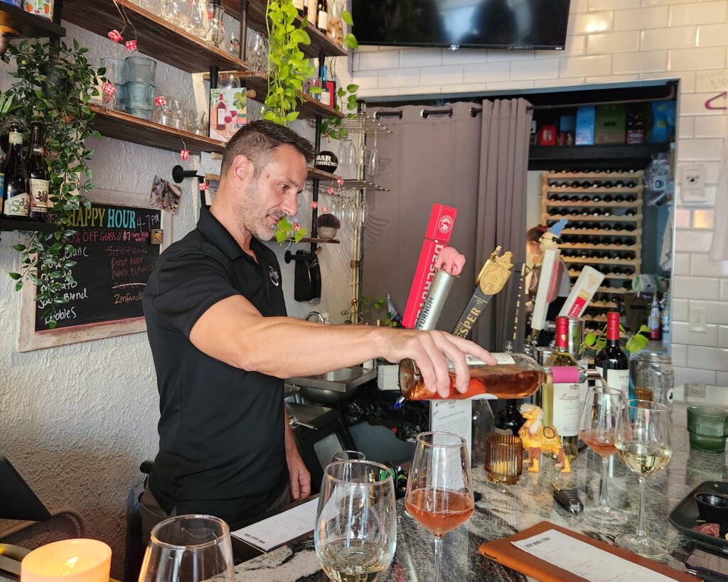 Andrea Andy Mezzari of BayVino tasting at bar chinchilla